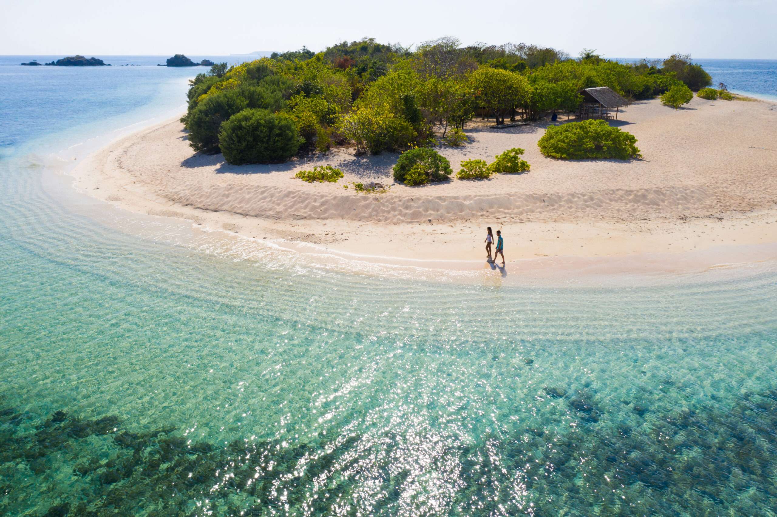 Tropical beach in Coron, Philippines Couple on a tropical beach with blue water and palm trees - Coron, Philippines